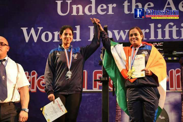 dharini's holding hand with gold medal