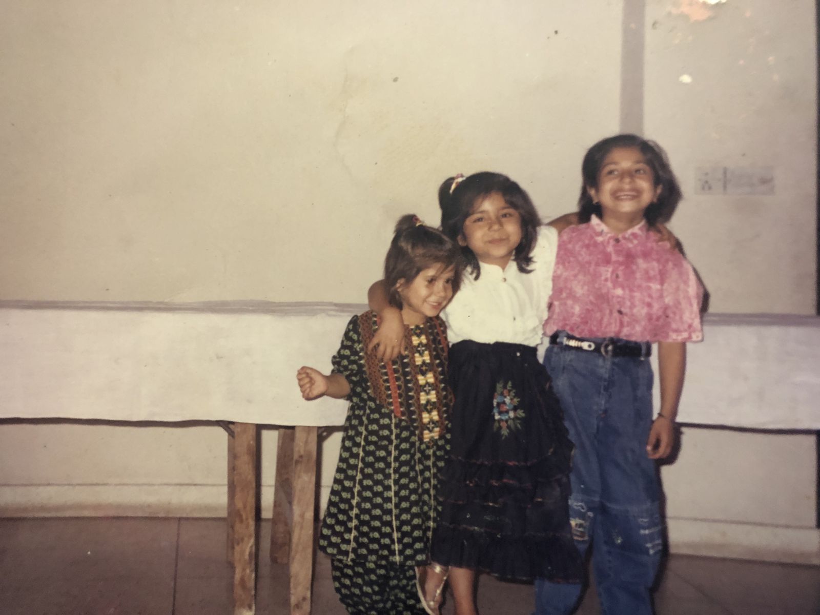 A CHILDHOOD PHOTOGRAPH WITH SISTER AND ANOTHER CHILD
